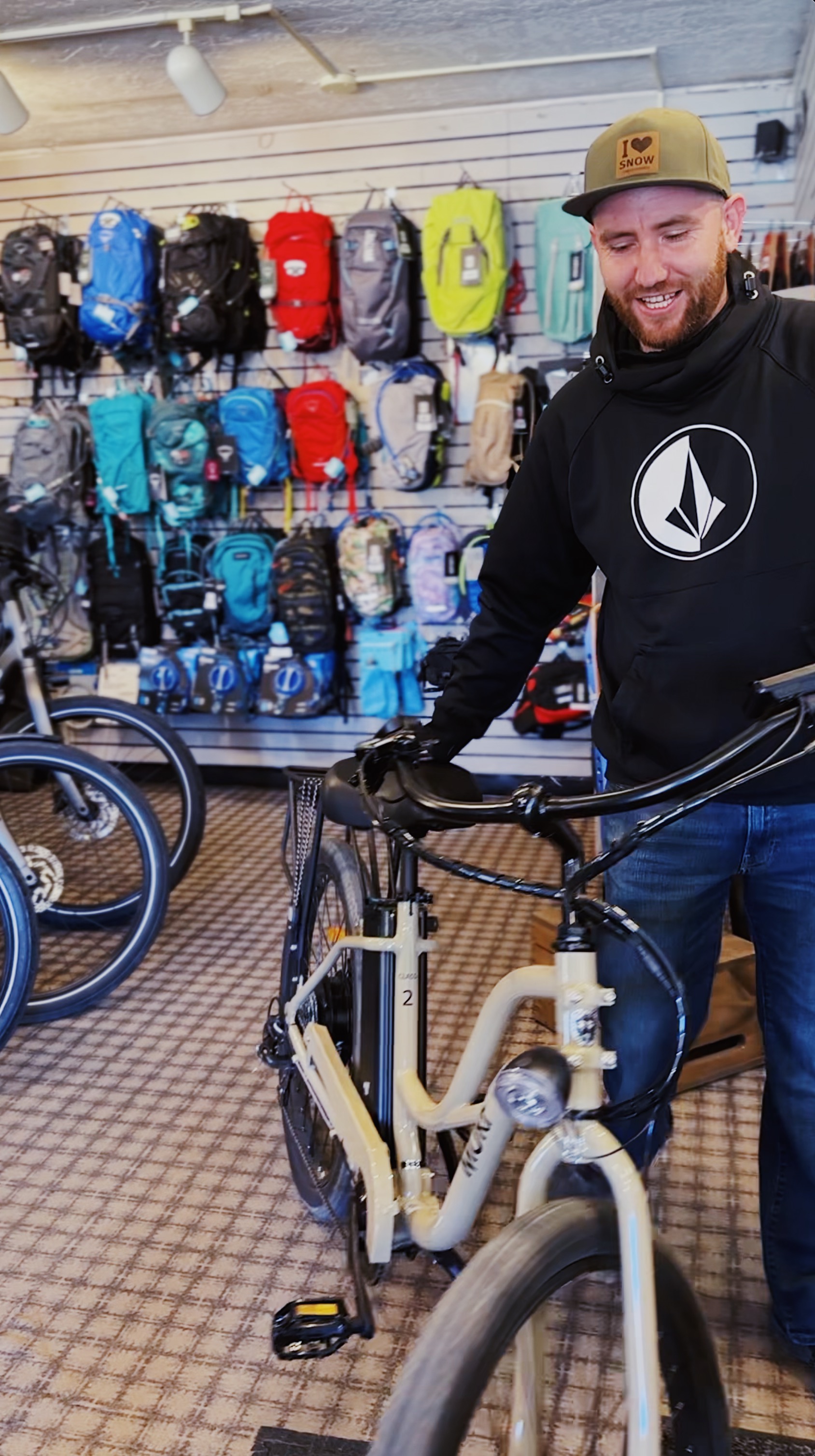 Image shows a bike technician getting a bike ready to ride at the Downtown Taos New Mexico Cottam's location