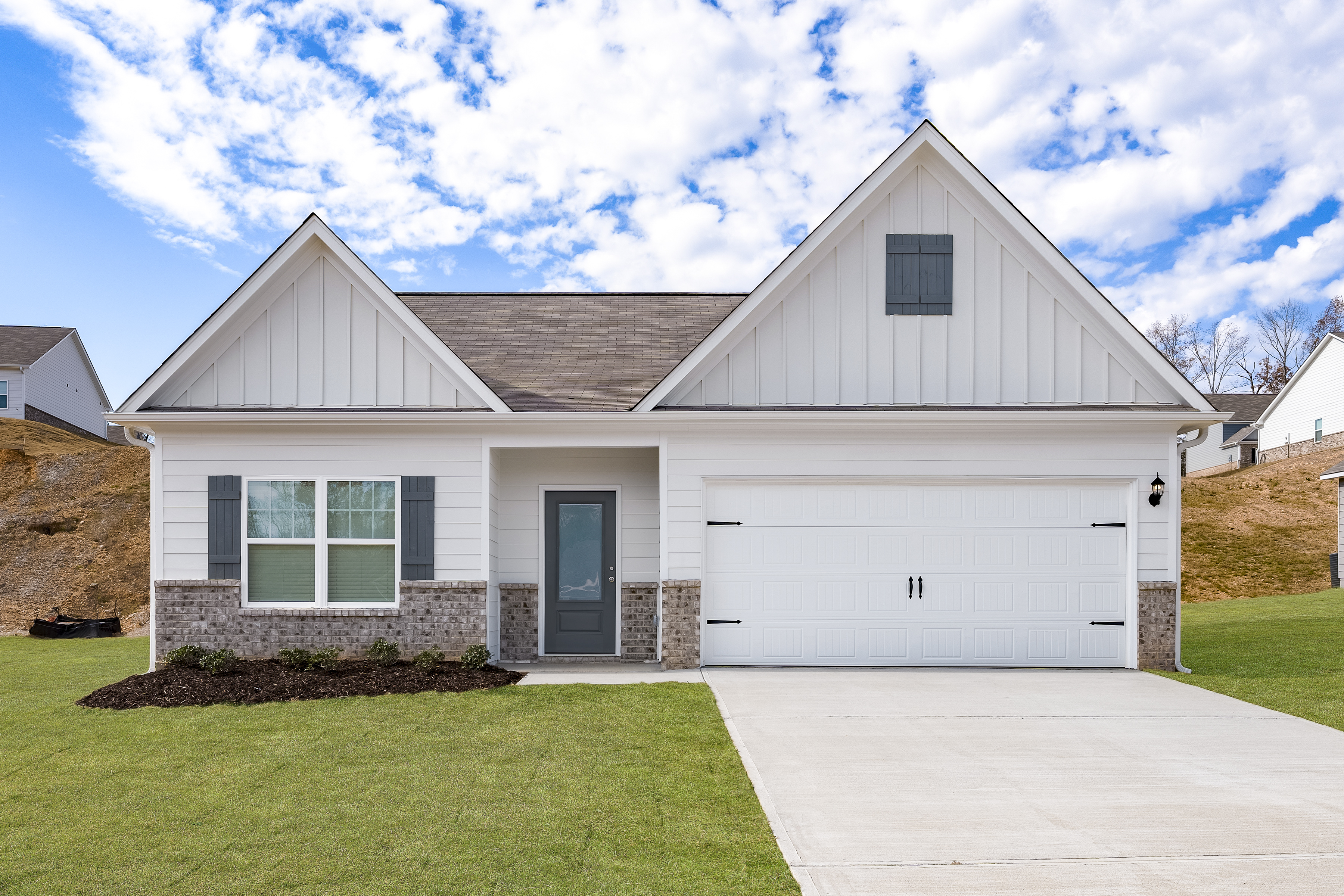 Photograph of the one-story Allatoona plan by LGI Homes in gray and sage green siding with white trim.