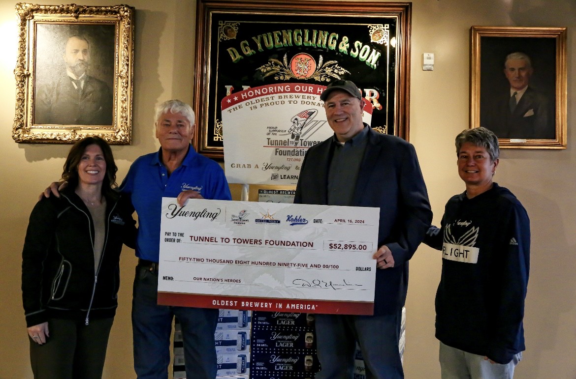 The Yuengling family presents a check to the Tunnel to Towers Foundation