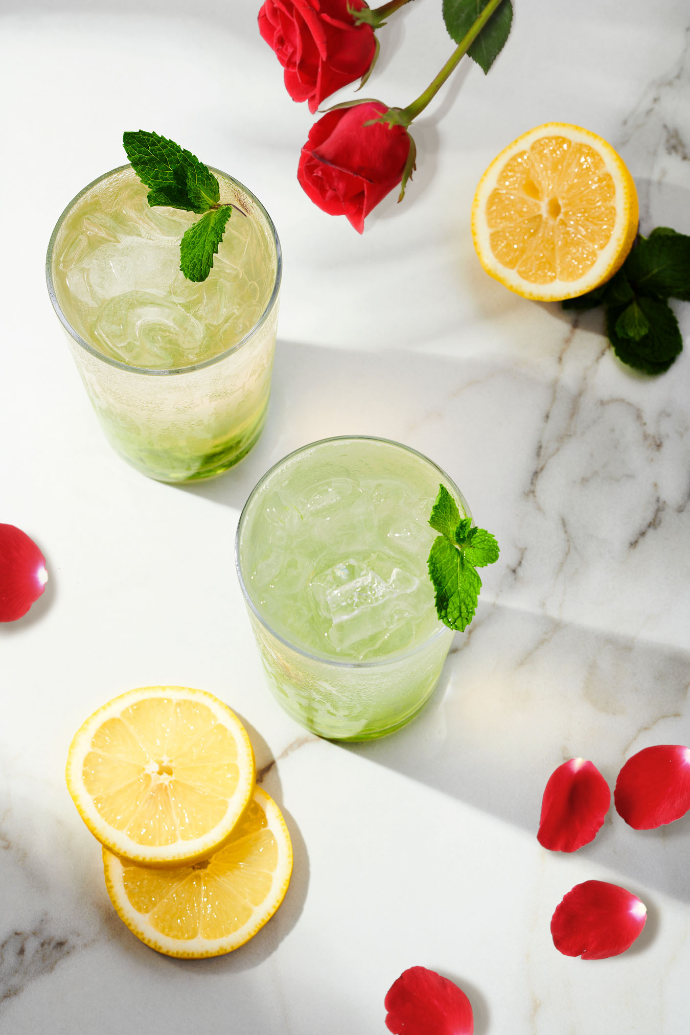 The Mint Rose-jito and Petal Nojito featuring Petal Sparkling Botanical Beverages, developed by award-winning mixologist Ivy Mix. This low-alcohol cocktail and alcohol-free mocktail is made with Petal Sparkling Botanical Blends Mint Rose. 