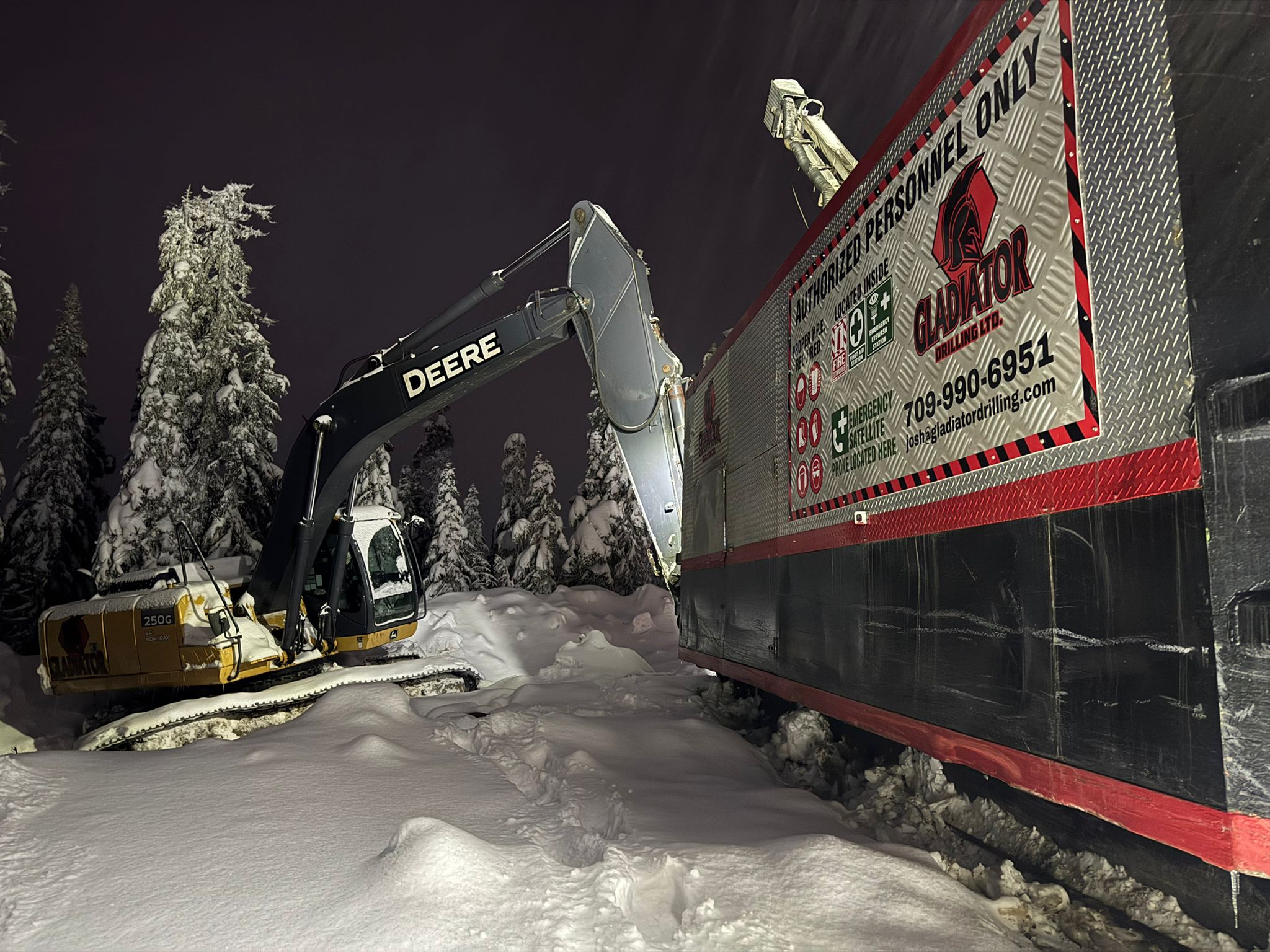 Figure 4: 25-tonne excavator moving the drill shack into position on drill hole R-0018. 