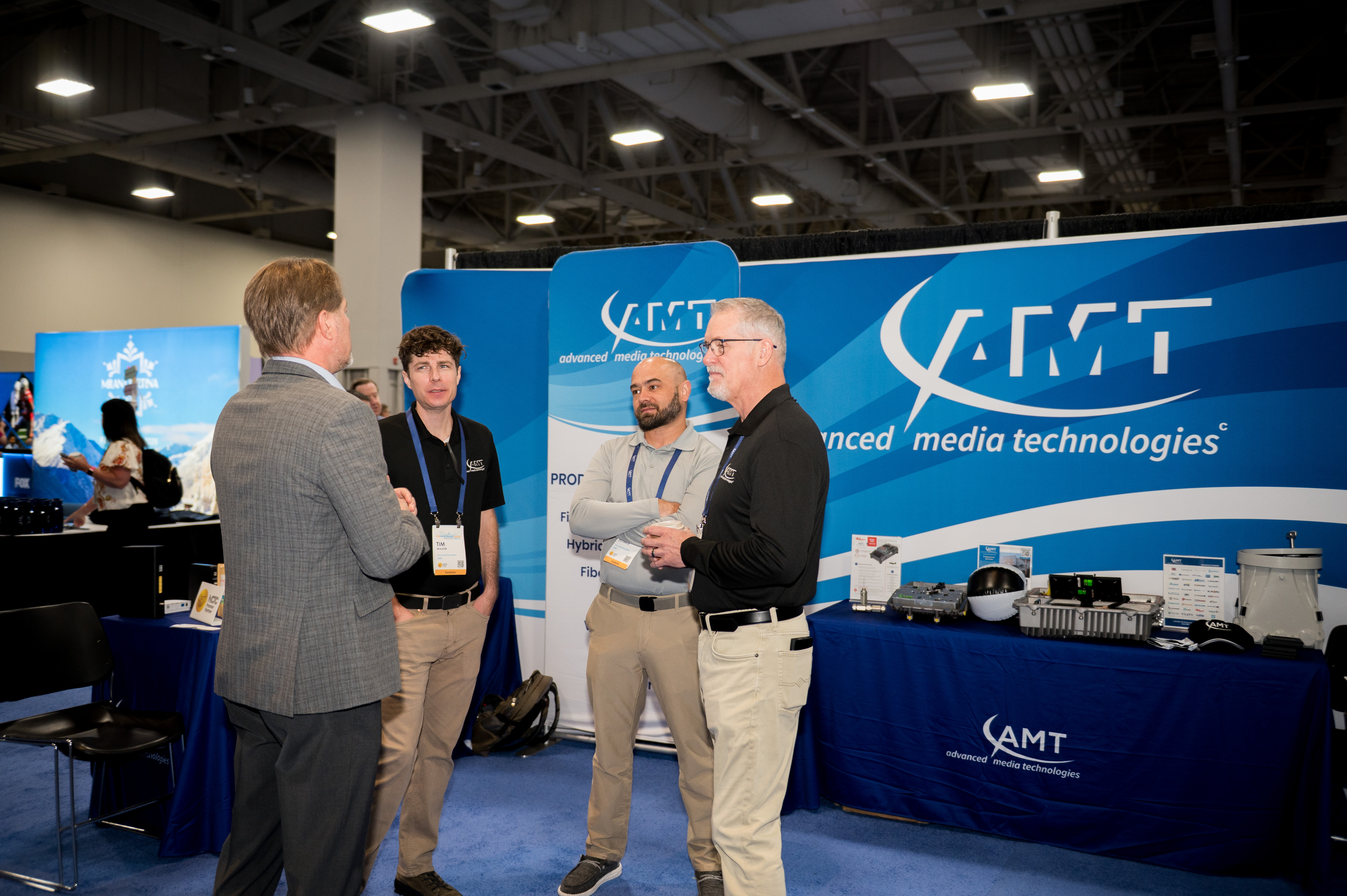Representatives from Advanced Media Technologies meet with attendees on the exhibition floor during The Independent Show.