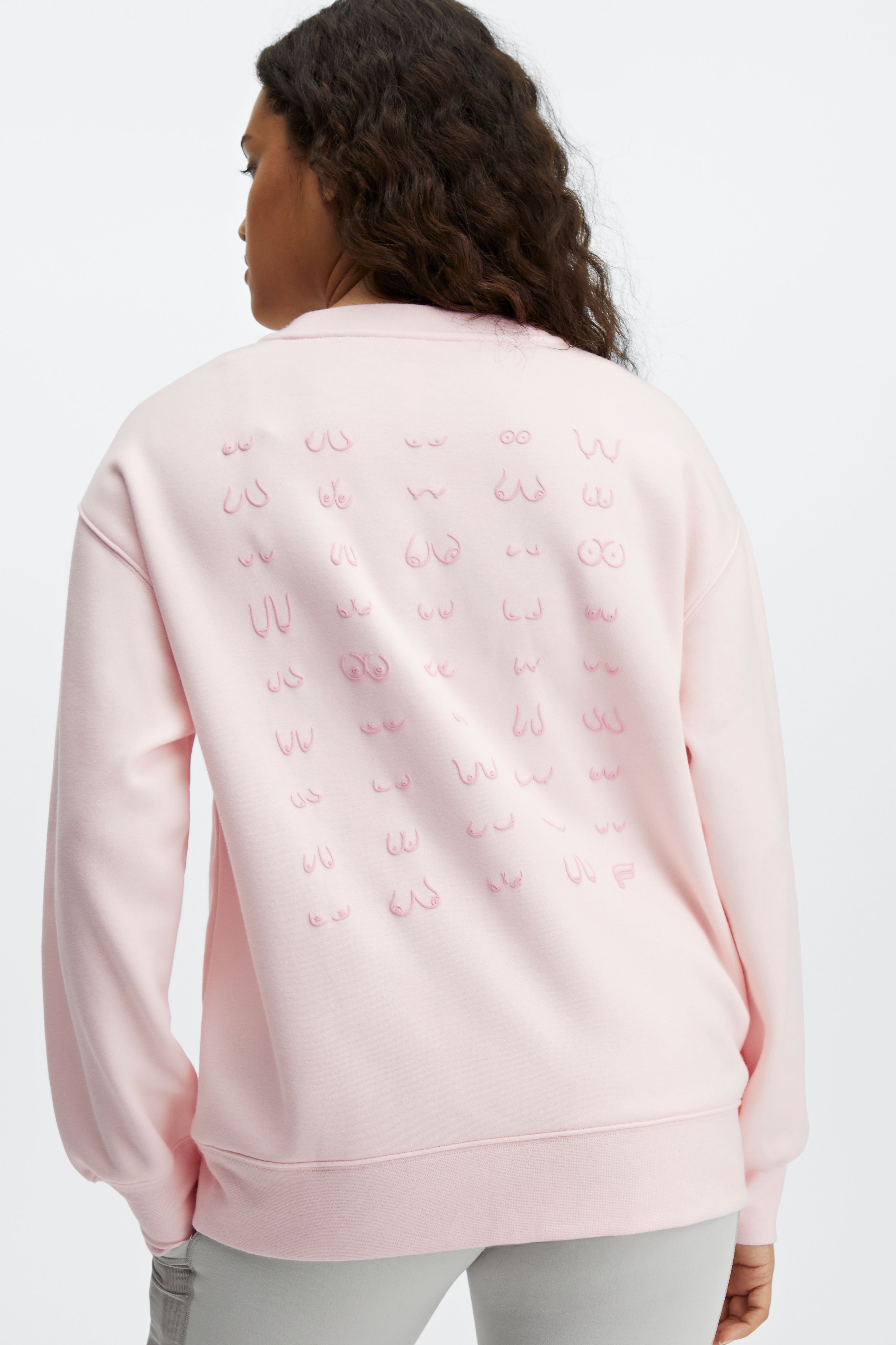 Fabletics launches custom Go-To Crewneck featuring illustration of women’s breasts in support of breast cancer awareness.