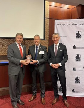 U.S. Representative Mike Rogers (R-AL) accepts the 2025 Sentinel Award presented by WPRC Board Chairman Markin Dornan and Executive Director David Costello