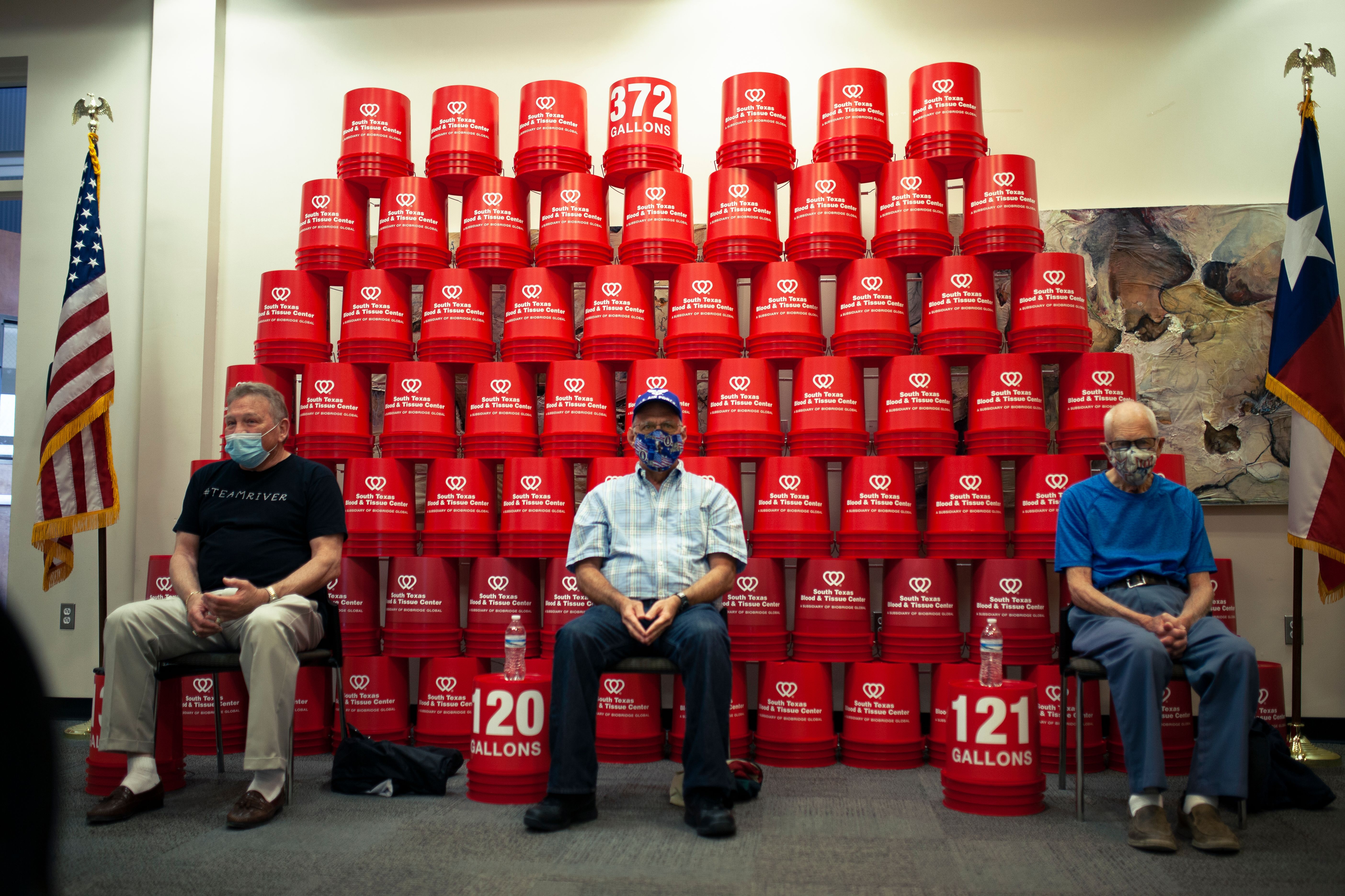 The South Texas Blood & Tissue Center's 'all-star' blood donors (from left) Ron White. Marcos Perez and Gerald Perkins, were recognized for donating 372 gallons of blood and platelets at an event at the South Texas Blood & Tissue Center's Donor Pavilion on Thursday, March 18. The stack of five-gallon buckets represent the 372 gallons of donations made by White (131 gallons), Perkins (121 gallons) and Perez (120 gallons).