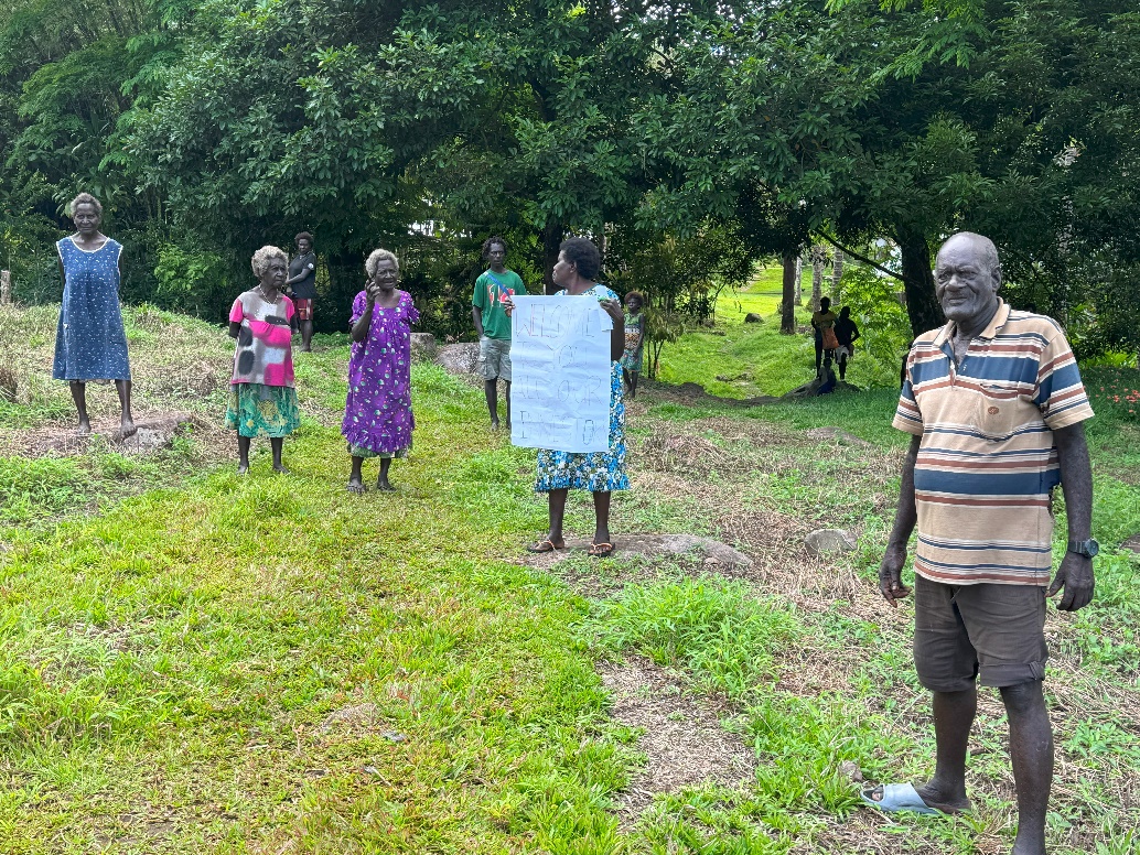 Paramount Chief David Dupound and clan members welcoming the IPX board of directors to Isina Village