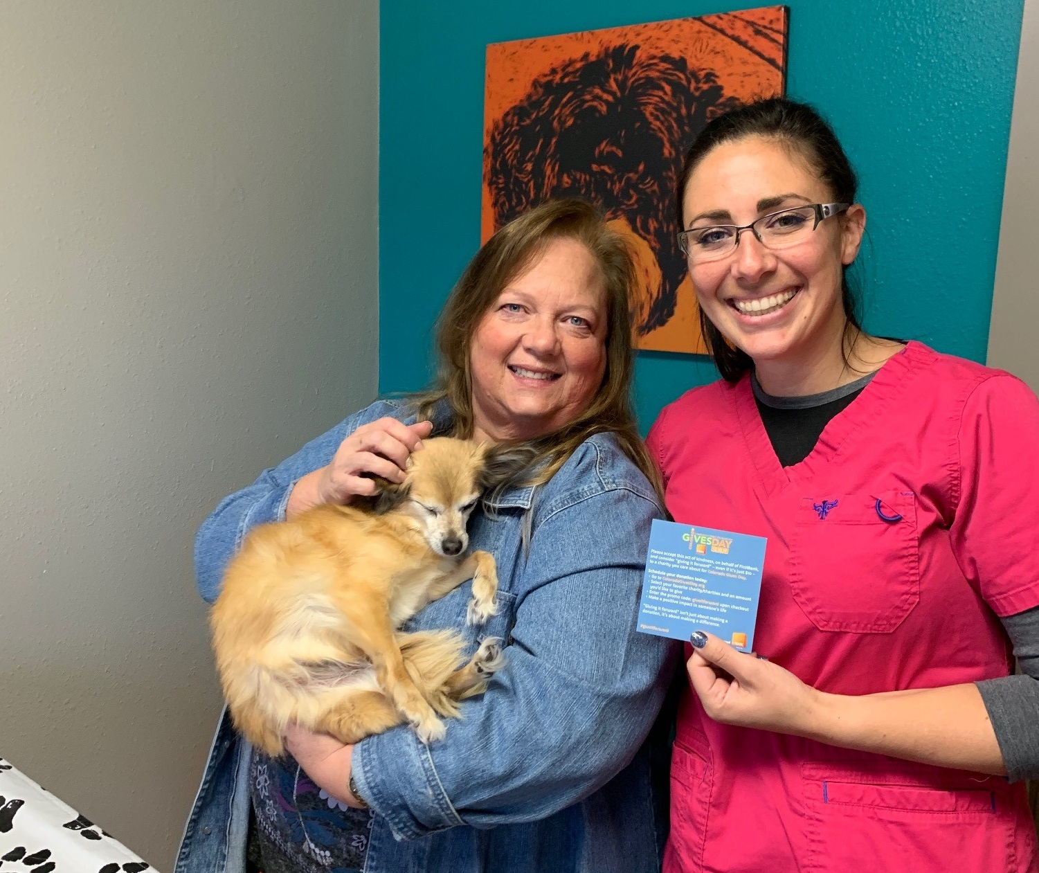 Stacey Novak, AVP at FirstBank, poses with a surprised pet owner at The Valley Veterinary Hospital in Rifle. FirstBank employees went undercover as "vet techs in training" and paid for over $40,000 in veterinary bills as part of its ‘Give it Forward’ campaign, which aims to inspire kindness and philanthropy for Colorado Gives Day (Dec. 10, 2019). Donations to support over 2,500 nonprofits can be made at coloradogivesday.org. 