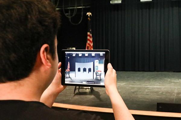 Thanks to advancements in augmented reality (AR), Husson University’s integrated technology department has begun development of an app for iPhones and iPads called AR Stagecraft, which leverages Apple’s ARKit to give users an immersive AR experience on an empty stage. Students in Husson’s entertainment production program are currently designing theater sets in a computer aided drafting (CAD) class, which will be imported into the AR Stagecraft app and provide users the experience of walking through a set on stage before construction ever begins. 