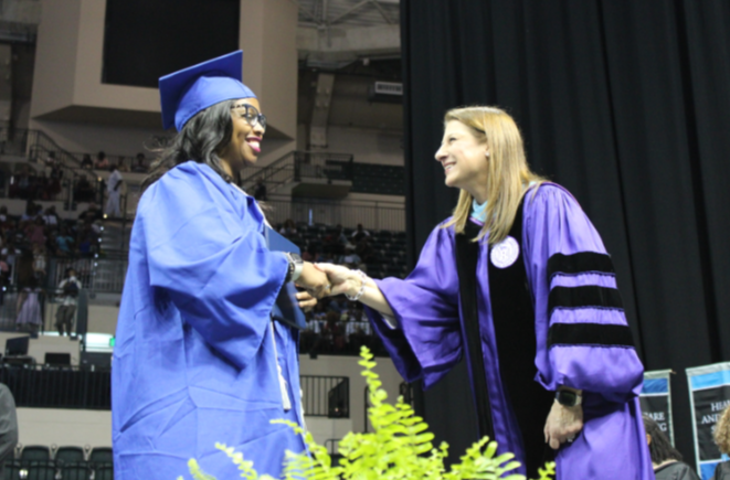 Dr. Shawntel Landry, UMA Chief Academic Officer, Congratulates a Graduate