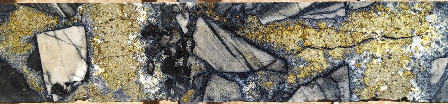 Typical breccia mineralisation at SFdLA: Tourmaline-sericite altered siltstone clasts set in an early quartz-tourmaline and later chalcopyrite-pyrite matrix. SFDH-035, 104.5m. From a 1m sample that averaged 3.48 g/t Au, 39 g/t silver and 1.2% copper. Photograph is of a selected interval and is not necessarily representative of mineralisation hosted throughout the property.