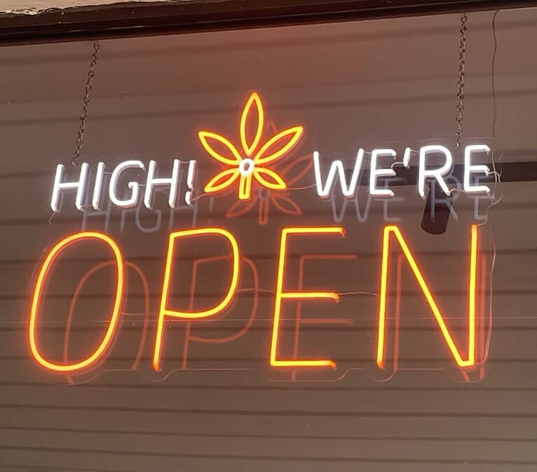 nuEra DeKalb's neon sign: "High We're Open"
