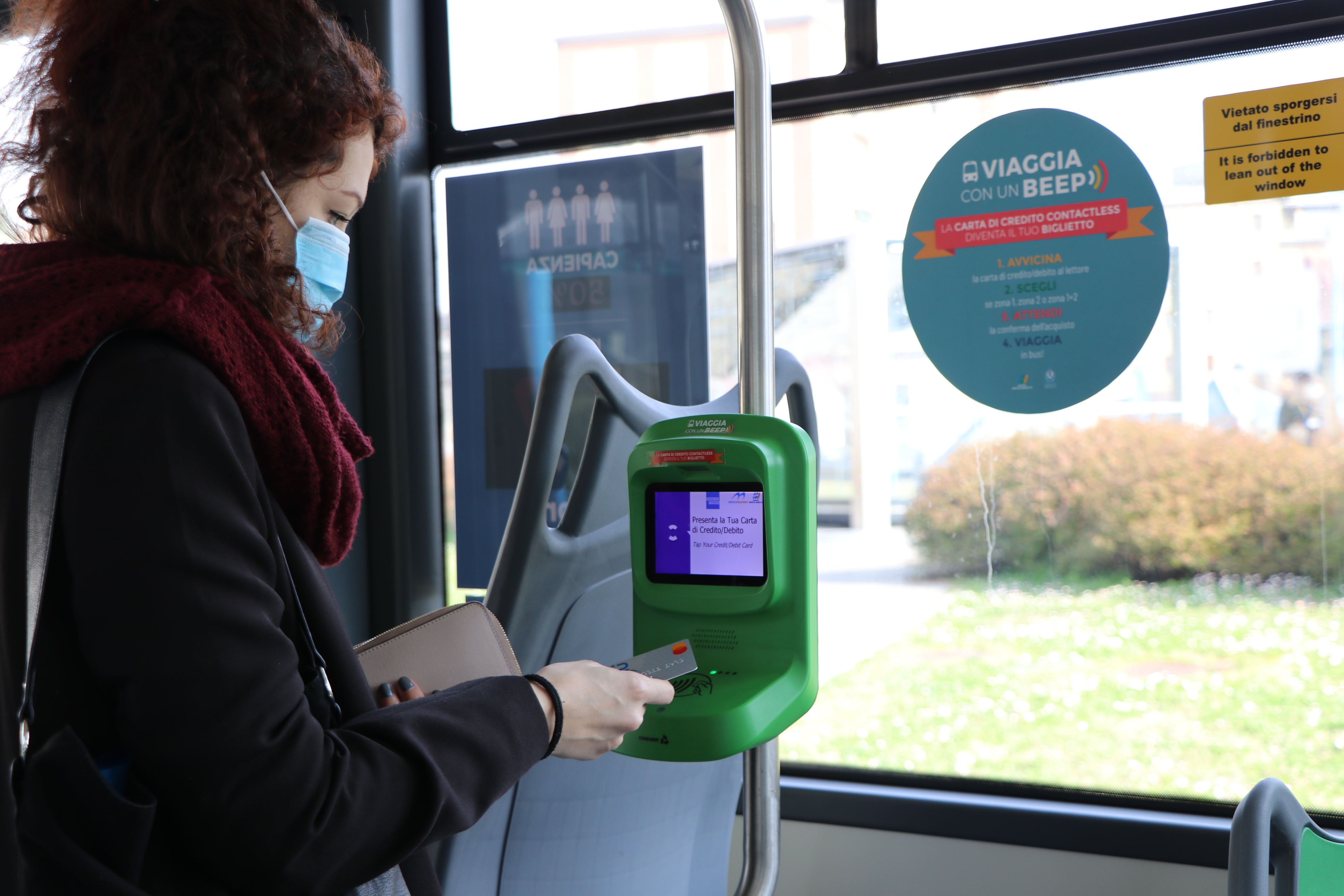 Traveller using contactless payment on Brescia Mobilità bus: Brescia Mobilità and Conduent Transportation Expand Contactless Payment to Area's Bus Fleet
