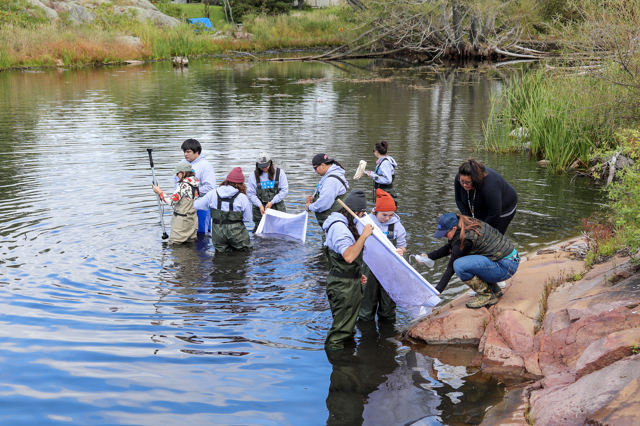 Drinking Water interns from Georgian Bay sampling sediment for analysis