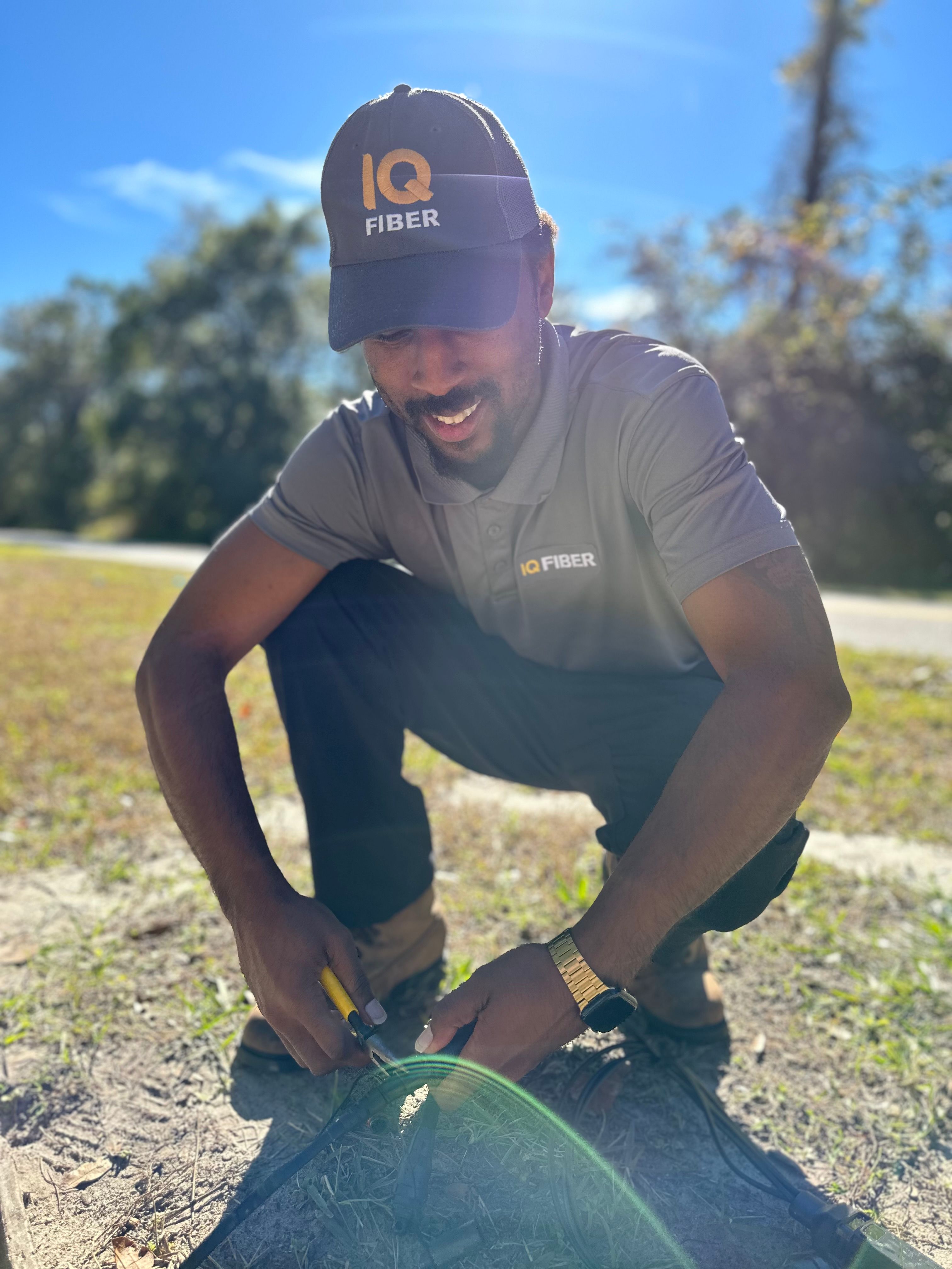 IQ Fiber drop technician Reko Womack (pictured) with a concrete fiber-optic vault. These concrete boxes house the fiber-optic cable underground and protect the network from severe weather.