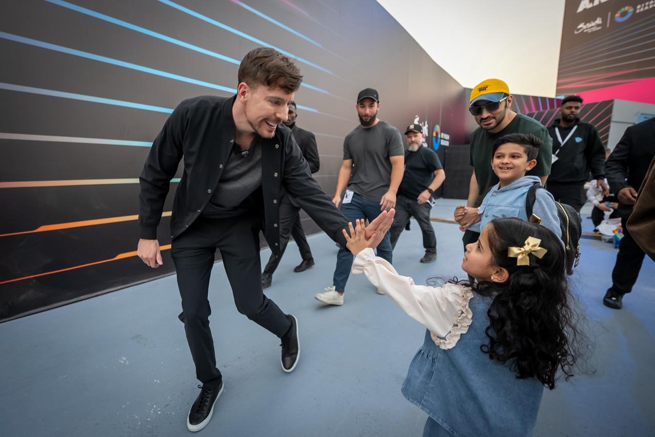 MrBeast shares a heartwarming moment with a young fan during the grand launch of Beast Land at Riyadh Season.