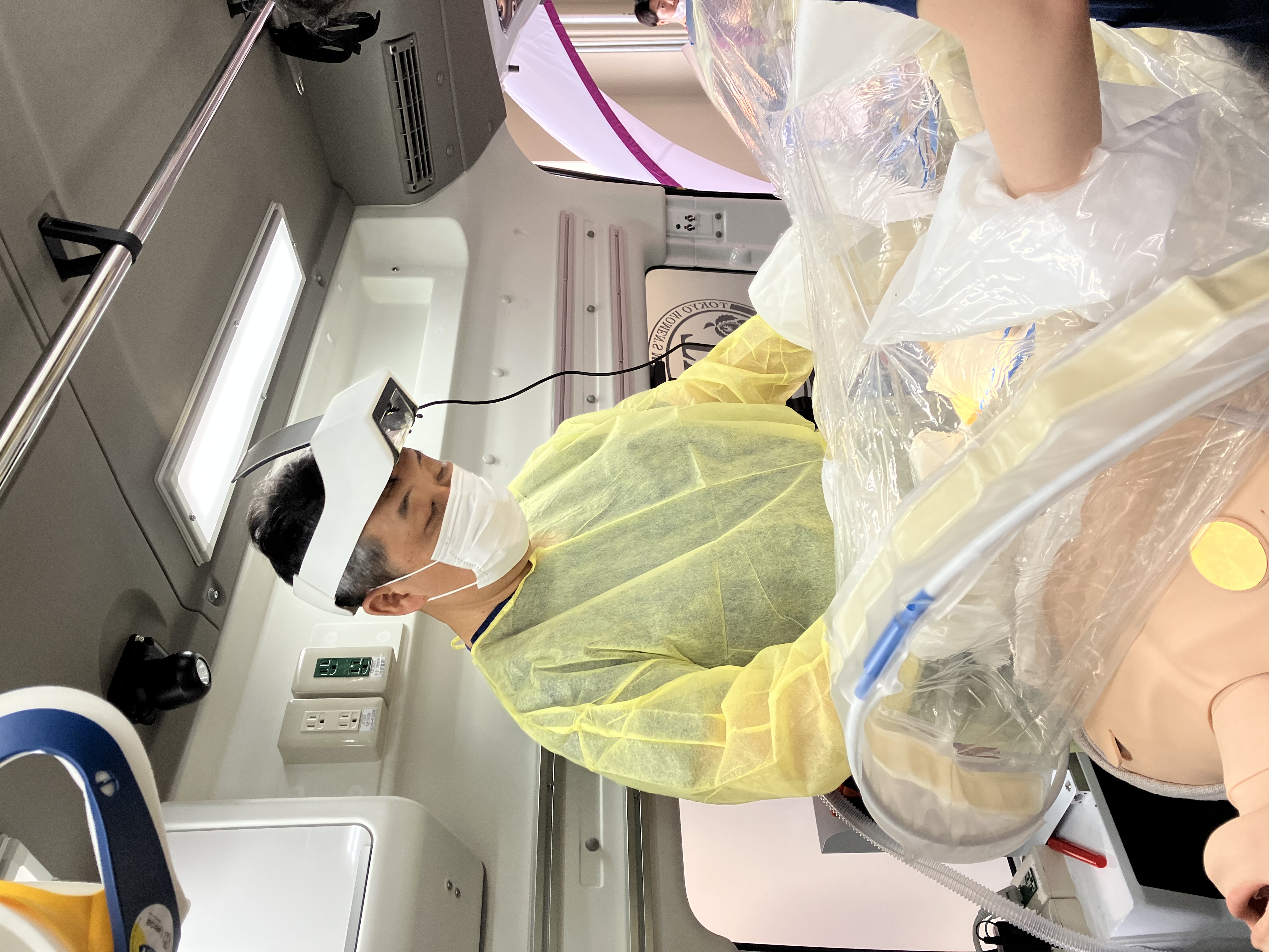Dr. Tomohisa Shoko, M.D., Ph.D., Professor and Director of Emergency and Critical Care Medicine at Tokyo Women's University Adachi Medical Center, testing the SurgiField system in a simulated field surgery inside an ambulance