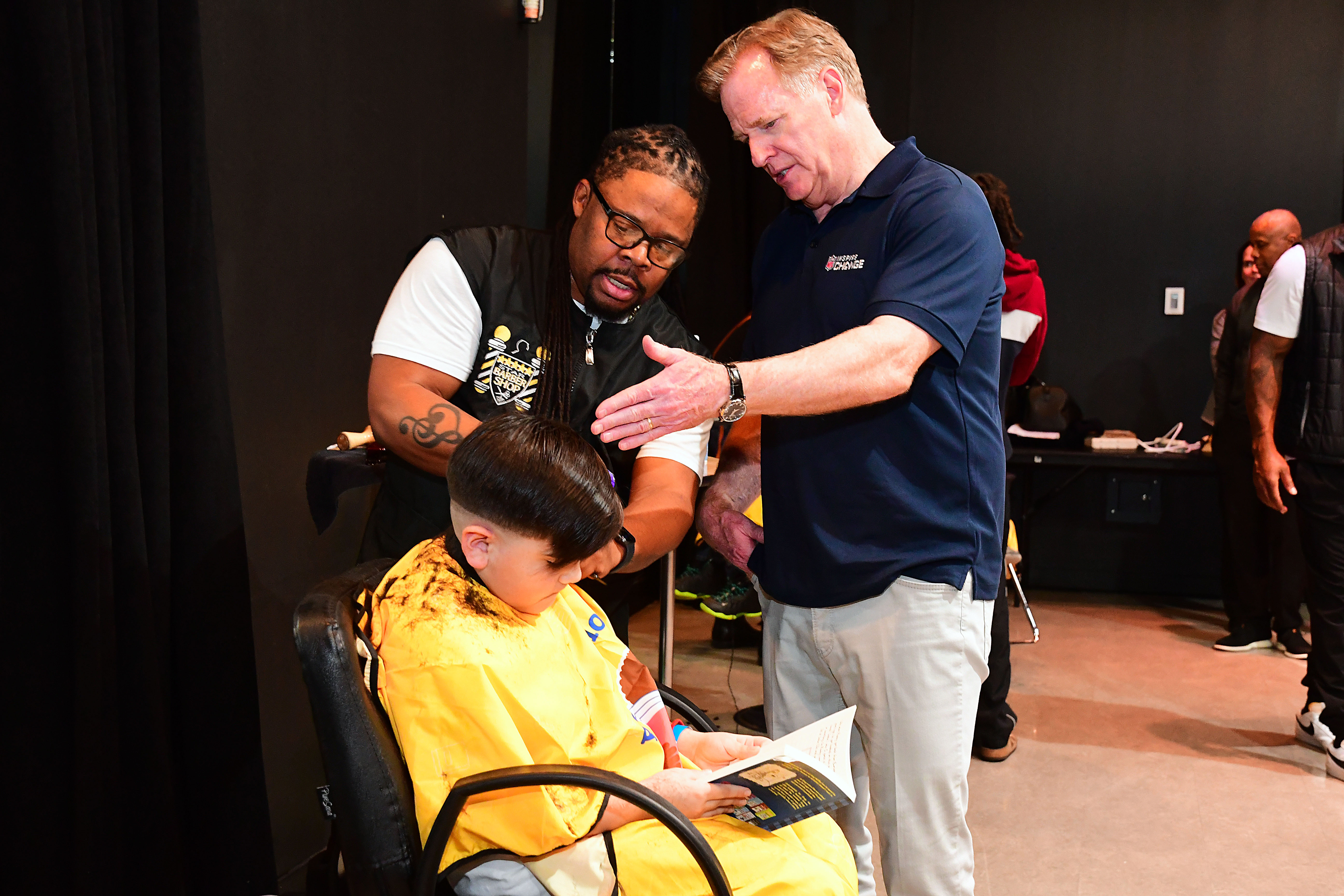 NFL Commissioner Roger Goodell, right, learns technique from Michael Joyner of 5 Star Barbershop at the launch of the Barbershop Books program in Las Vegas.