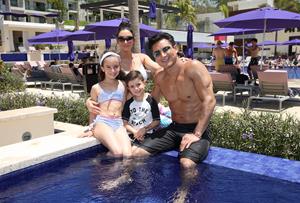 Mario Lopez sitting poolside with his family